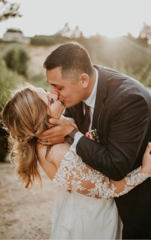 Сouple wearing a white gown and a black suit